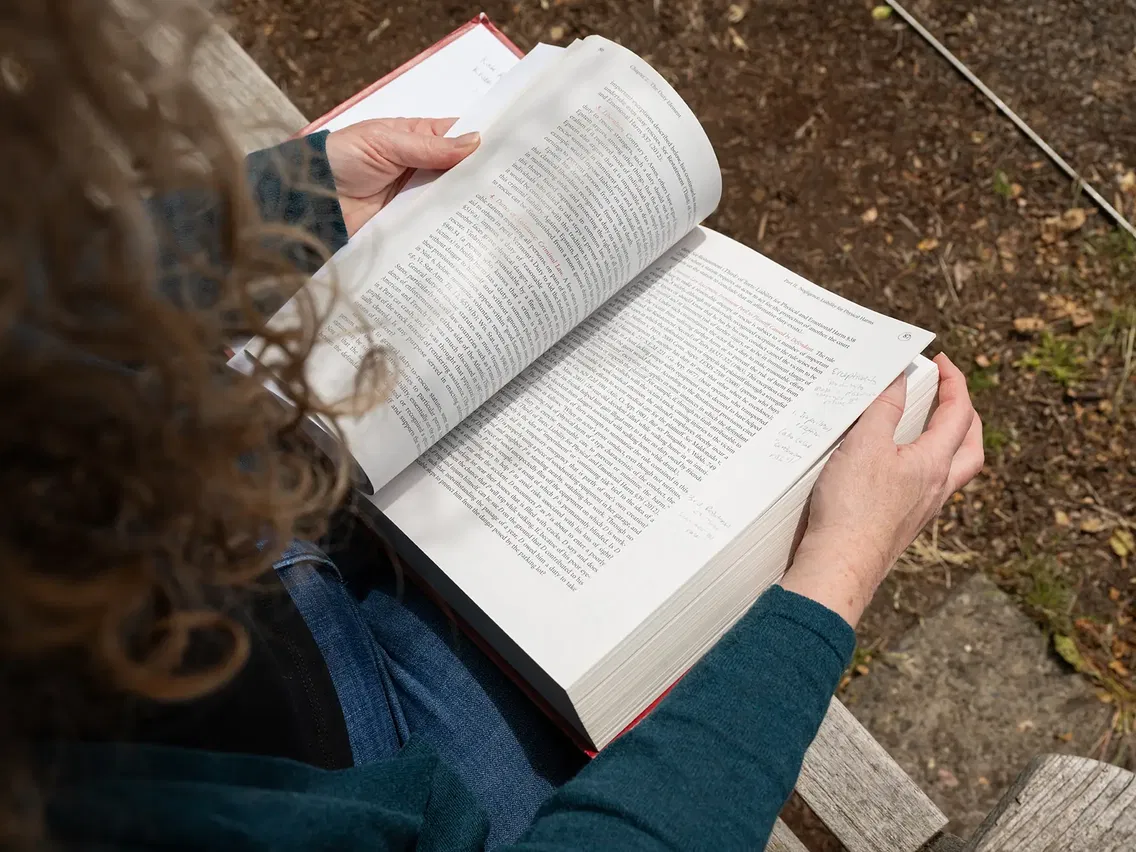 Kate holding a legal textbook