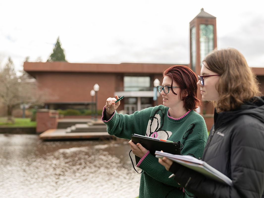Two students working on research on the Mill Stream